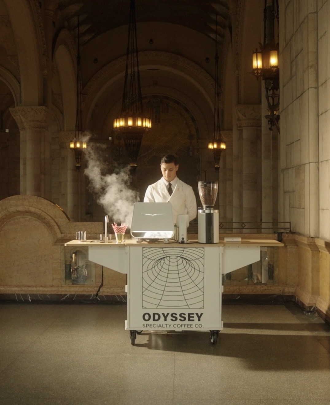 Odyssey specialty coffee cart in a grand cathedral hall